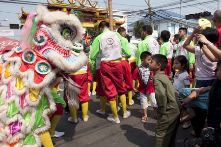 Nakhon Sawan, Thailand - February 6,2011 -  acrobatic lion dancer and boy look each other in chinese new year celebrationのeditorial素材