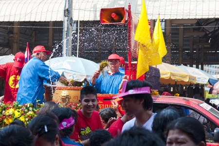 Nakhon Sawan, Thailand - February 6,2011 - Man gives holy water from Thai temple to the people  in chinese new year celebrationのeditorial素材