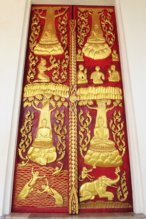 Golden religion story on red wood doorの写真素材