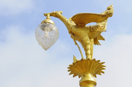 Golden bird statue on the top of poleの写真素材