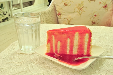Crape cake on plate with strawberry sauceの写真素材