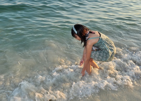 Young woman play the seaの写真素材