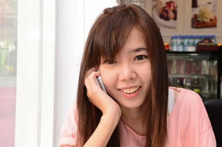 Happy girl smiling and speaking telephoneのeditorial素材