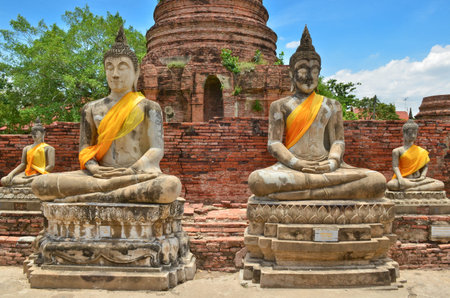 Ancient buddha statues with blue sky at Wat Yai Chaimongkol, Ayutthaya, Thailand 