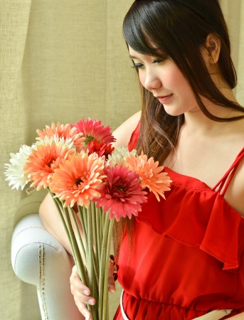 Beautiful woman with bouquet flowersの写真素材