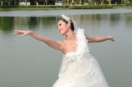 Beautiful girl in white gown of the bride danceの写真素材