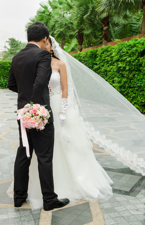 Groom and bride with wedding flowers bouquetの写真素材