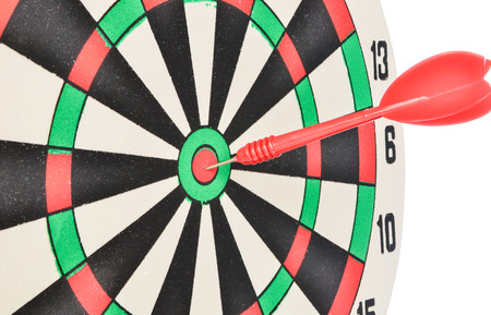 Dartboard with red dart at the center isolated on white backgroundの写真素材