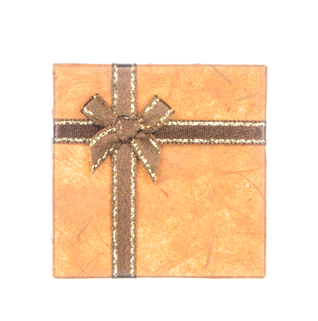 Orange gift box with ribbon and bow isolated on white backgroundの写真素材
