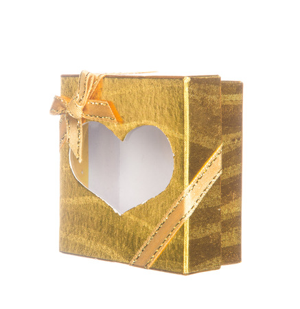 Gold gift box with heart shape isolated on white backgroundの写真素材