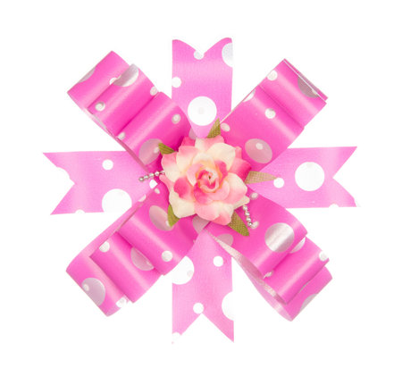 Pink ribbon bow with flower isolated on white backgroundの写真素材