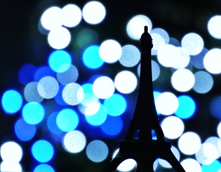 miniature Eiffel tower against blue lightsの素材