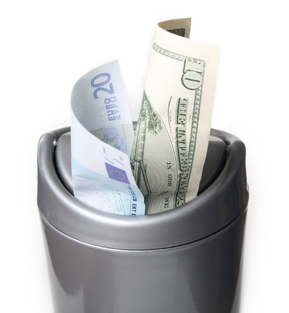 Money in trash bin, isolatedの写真素材