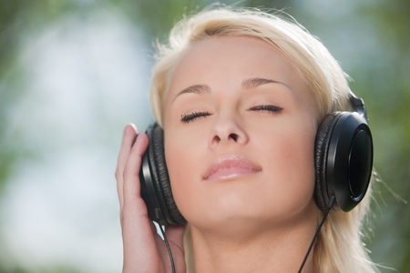 Young woman listening music in headphones with closed eyesの写真素材