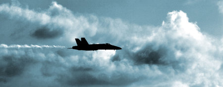 A single US Navy FA18 Blue Angel Hornet on patrol in steel blue skies