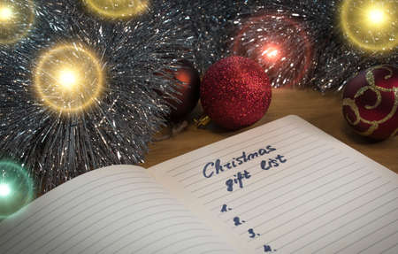 Handwritten Christmas gift list for a family. An English text handwritten in a paper notebook "Christmas gift list - mom, dad, sister".の写真素材