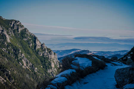 Panoramic view of lower hills and and Pieniny Mountain Range seen from Tatra National Park, Poland. Selective focus on the rocks, blurred background.の写真素材