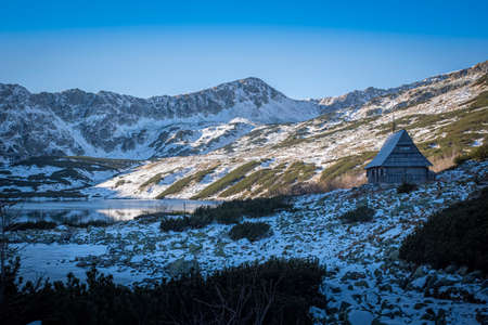 Tatra Mountain valley once used for sheep herding. Old pasture hut is still standing as a cultural and architectural heritage. Selective focus on a building, blurred background.の写真素材