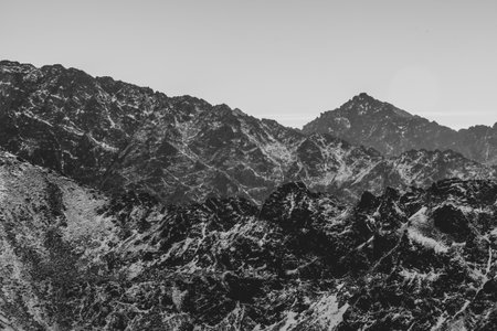 Layers of mountain ridges in black and white, Tatra National Park, Poland. The view to Slovak side of High Tatras. Selective focus on the rocks, blurred background.の写真素材