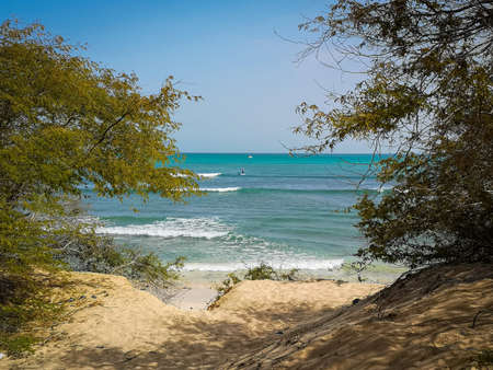 Lonely paddle boarder in Atlantic Ocean, Cape Verde. A person swimming on a standup paddle board in open water. Selective focus on the horizon, blurred background.の写真素材