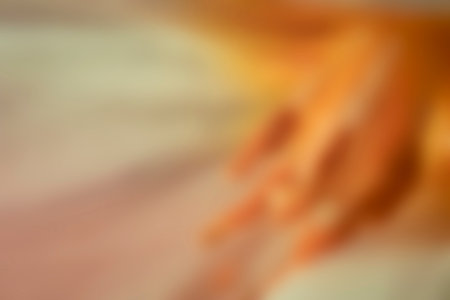 Bright orange color blurry wallpaper. Floral pattern, blurred ornaments, smooth texture. Easter postcard. No selective focus, defocused background.の写真素材