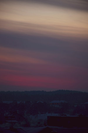 Warm evening colors in cold winter. Dusk in the sky, colorful pastel clouds illuminated by the...