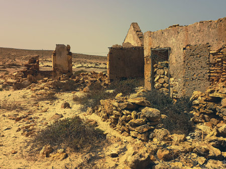 Old stone wall remains in Africa, Cape Verde. Traditional village architecture ruins, sunny desert,...