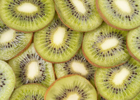 Close up macro kiwi slices texture as background close-up, top view of chopped fresh kiwi fruitの写真素材