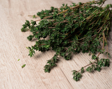 Thyme bunch. Bundle of fresh thyme on a wooden background