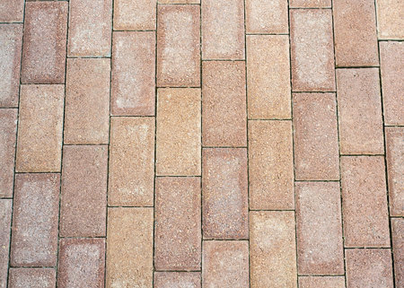 Outdoor concrete block floor background and texture. Top view on gray paving stone road. Old...