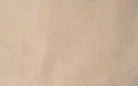 Canvas pattern in natural tone. Abstract background and texture for design. close up of linen textile, beige background, fabric texture in high resolutionの写真素材