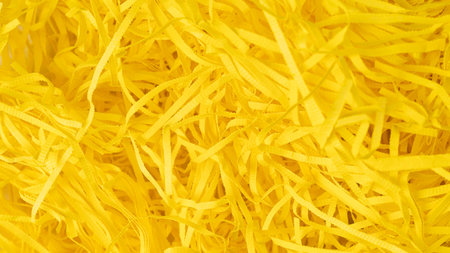 texture yellow paper shavings texture for filling gift boxes and gift wrapping. background in high...