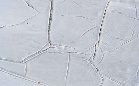 Old white peeled plaster wall with cracked structure frame empty grunge background. Gray brick wall with shabby stucco layer isolated. Renovation concept. Blank peeled surfaceの写真素材