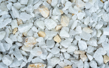 White decorative stones interior decoration. Small White and yellow pebble background. Top view of...