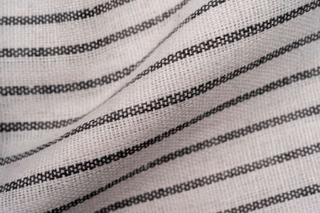 Kitchen towel or napkin crumpled over the table View from above with copy space for design, wrinkled kitchen towel, black lines on towel, selective focusの写真素材