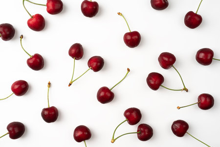 Fresh summer dark red sweet cherry isolated on a white background Pattern with sweet cherry top view