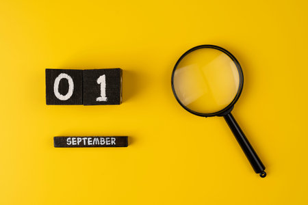 magnifying glass magnifier glass search symbol on yellow background with copy space, 1st September...