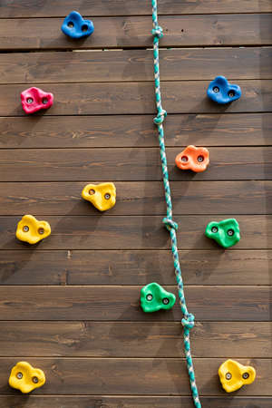 Kids climbing on wooden wall outdoor. vertical image. climbing on the playground wooden wall outdoors.の写真素材