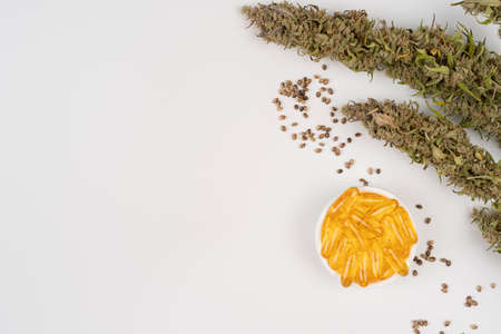 Assorted medical cannabis products with bud and CBD oil capsules isolated over white background with copy space for textの写真素材