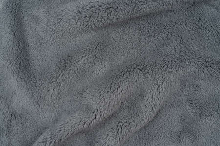 Beautiful abstract close-up beige plush soft background texture. Background of cozy warmed material. Gray plaid textureの写真素材