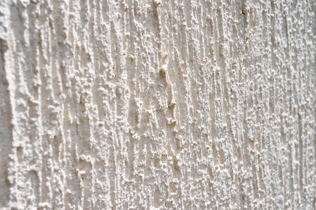 Grungy white concrete wall background with cracked texture in high resolution. Grunge white background cement old texture wall close up, top view with copy spaceの写真素材