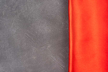 Gray concrete background with red silk or satin border, top view, background with texture and copy space for text or design. close up viewの写真素材