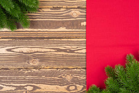 High angle view of Christmas ornaments on wooden table with copy space. Top view of fir branch with red borderの写真素材