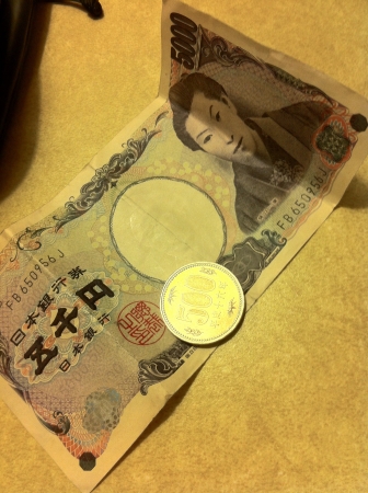 A photo of a 5000 Yen notes and a 500 Yen coin.の素材