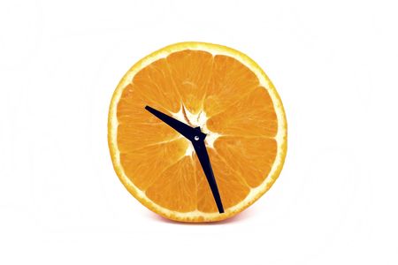 A mature orange, analogous one symbolize a clock.の写真素材