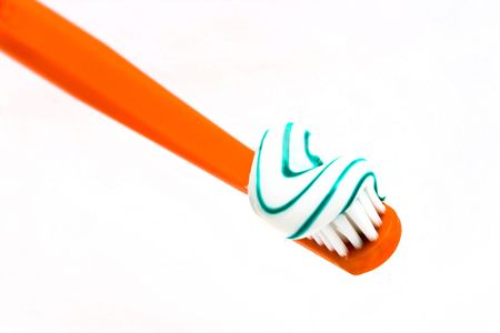 Orange color toothbrush dentifrice white background isolate.の写真素材