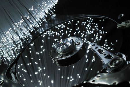 Computer hard disc, illuminated optical fiber. の写真素材