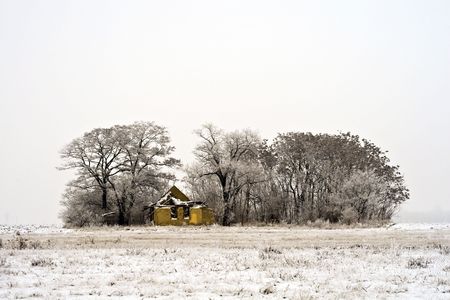 Abandoned farm in the winter landscape.の写真素材