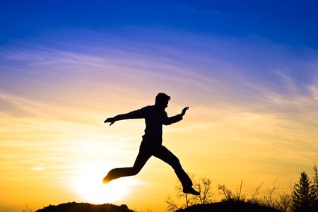 Man jumping in the sunset.の写真素材