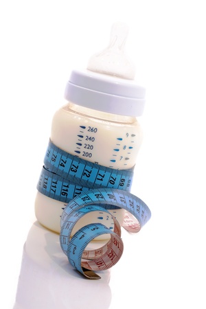 Baby feeding bottle of the tape measure around it.の写真素材